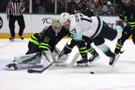 Seattle Kraken center Jaden Schwartz (17) falls as he tries to shoot on Dallas Stars goaltender Jake Oettinger (29) during the second period of an NHL hockey game on Saturday, April 13, 2024, in Dallas. (AP Photo/Richard W. Rodriguez)