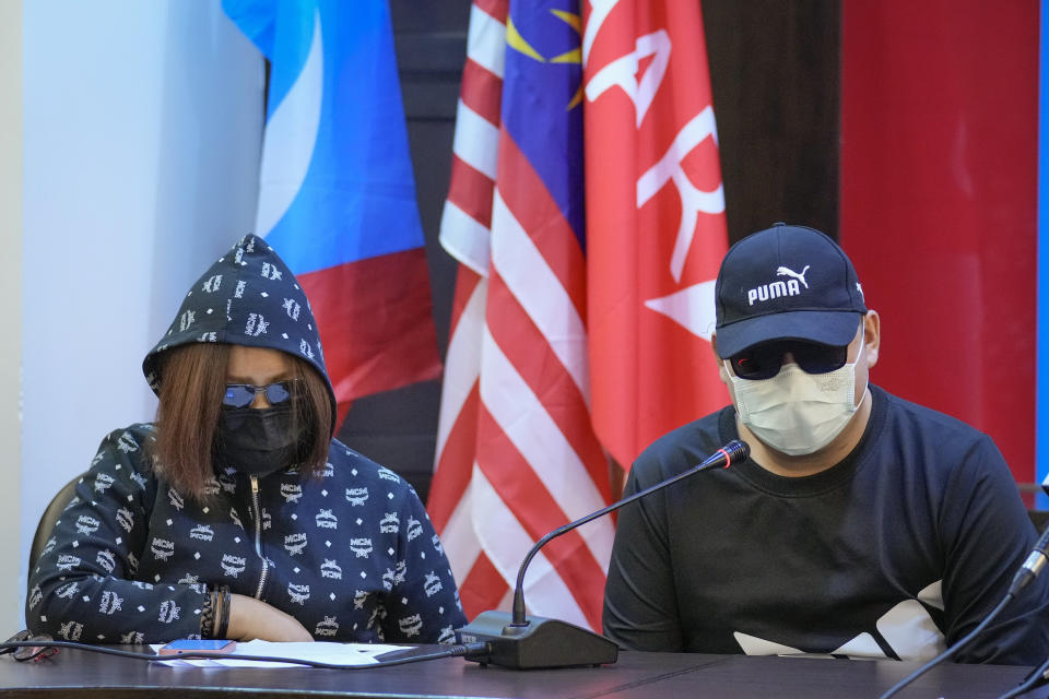 Malaysian victims of job scams attend a press conference in Petaling Jaya, outskirts of Kuala Lumpur, Malaysia, Wednesday, Sept. 21, 2022. The duo, who declined to be named for fear over their safety, said they were offered high paying jobs in Thailand that turned out to be a scam. Instead they were taken to a casino complex in Myanmar near the Thai border. (AP Photo/Vincent Thian)