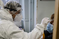 A student of the Emile Dubois high school takes part to a COVID-19 antigen test in Paris, Monday Nov. 23, 2020. Experts said they are less accurate than the standard PCR test, which detects even the tiniest genetic trace of the virus. Many governments including in France have started deploying them as a precursor to PCR tests.( Ludovic Marin, Pool via AP)