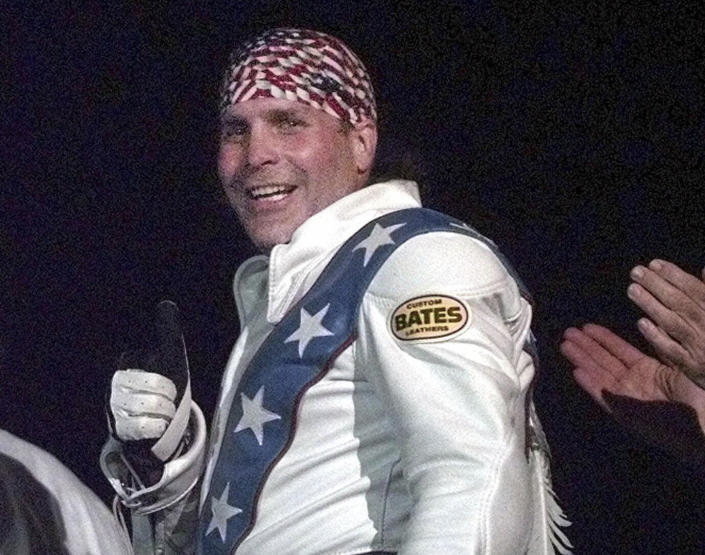 FILE - Robbie Knievel gives a thumbs up after jumping a train at the Texas State Railroad Park in Palestine, Texas on Feb. 23, 2000. (AP Photo/LM Otero, File)
