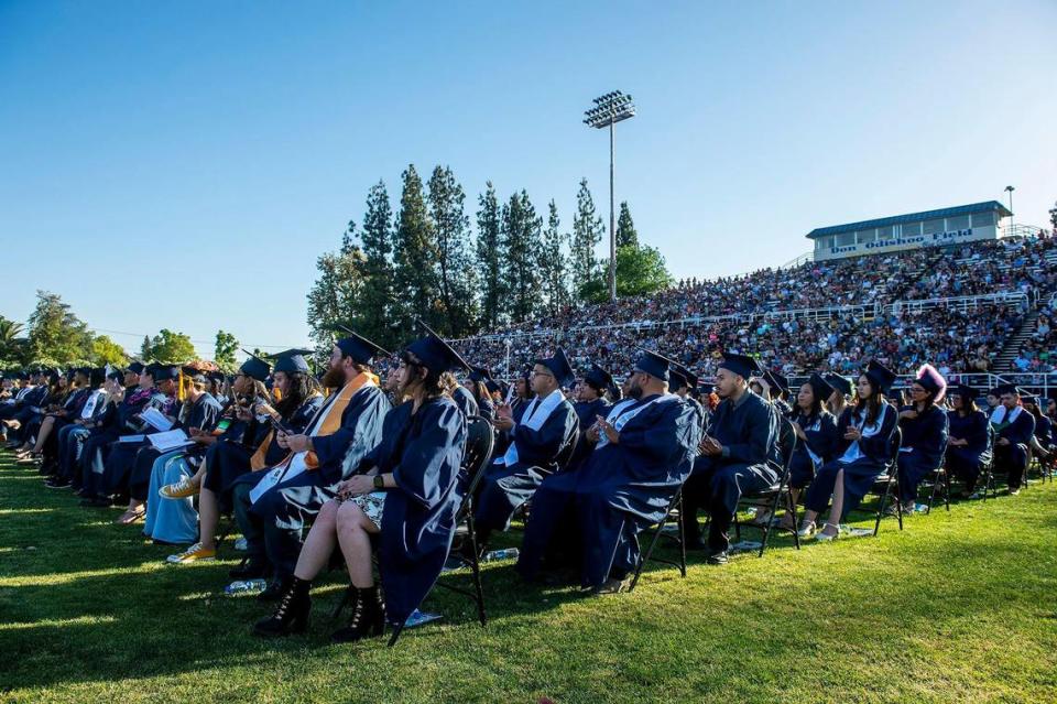 Graduates look on during a commencement ceremony for the Merced College class of 2022 on the Don Odishoo Field at Stadium ’76 in Merced, Calif., on Friday, May 20, 2022.