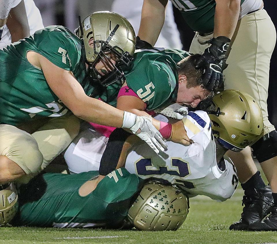 St. Vincent-St. Mary defenders take down Hoban's Lamar Sperling on Friday, Oct. 7, 2022 in Akron, Ohio, at John Cistone Field.  [Phil Masturzo/ Beacon Journal]