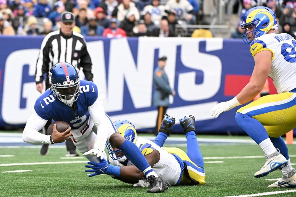 The Rams' Kobie Turner (91) sacks Giants quarterback Tyrod Taylor. Turner finished the game with 2½ sacks.