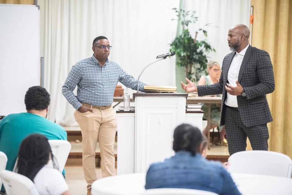 Attorney Sayge Grubbs and City Councilman Oronde Mitchell talk with residents about a housing lawsuit for unlivable conditions in Montgomery, Ala., on Thursday, April 4, 2024.