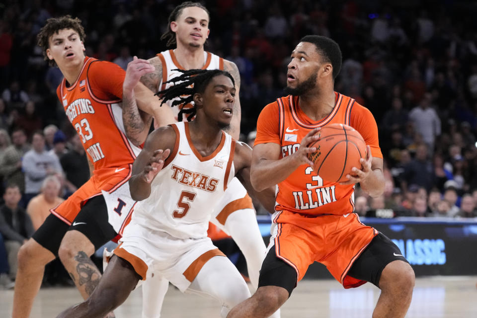 Illinois' Jayden Epps (3) eyes the basket against Texas' Marcus Carr (5) in overtime during the team's NCAA college basketball game in the Jimmy V Classic, Tuesday, Dec. 6, 2022, in New York. (AP Photo/John Minchillo)