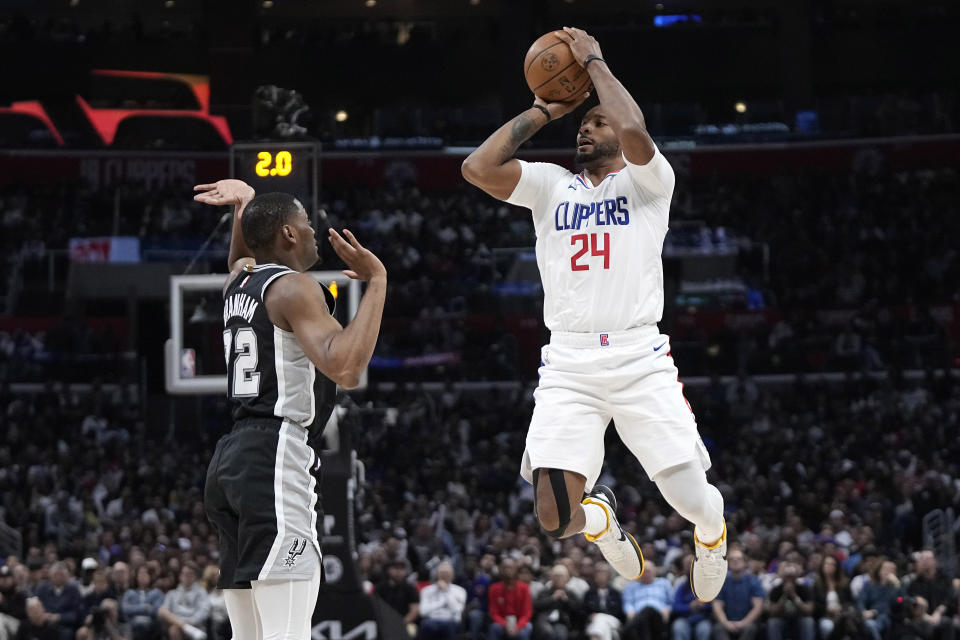 Los Angeles Clippers guard Norman Powell, right, shoots as San Antonio Spurs guard Malaki Branham defends during the second half of an NBA basketball game Sunday, Oct. 29, 2023, in Los Angeles. (AP Photo/Mark J. Terrill)