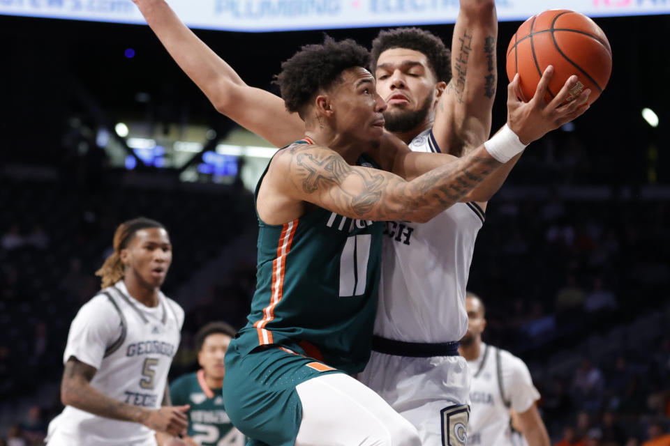 Miami guard Jordan Miller, front, drives to the hoop basket against Georgia Tech center Rodney Howard, right, during the first half of an NCAA college basketball game Wednesday, Jan. 4, 2023, in Atlanta. (AP Photo/Alex Slitz)
