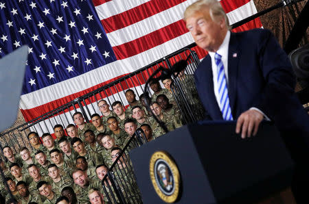 U.S. Army 10th Mountain Division troops listen as President Donald Trump speaks before signing the National Defense Authorization Act. Trump signed the law at the U.S. Army's Fort Drum base in upstate New York on his way back to Washington after a 12-day working vacation at his golf club in New Jersey. REUTERS/Carlos Barria