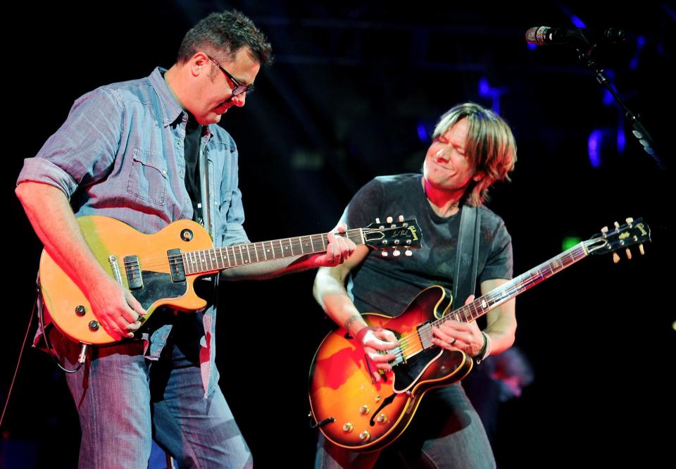 Hosts Vince Gill, left, and Keith Urban perform together during the We're All for the Hall Concert benefitting the Country Music Hall of Fame and Museum at the Bridgestone Arena April 10, 2012.