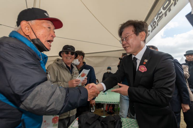 Democratic Party of Korea Chairman Rep. Lee Jae-myung greets a Jeju islander during the memorial ceremony marking the 75th anniversary of the Jeju Massacre at the Jeju 4.3 Peace Park, Jeju City, on April 3. File Photo by Darryl Coote/UPI