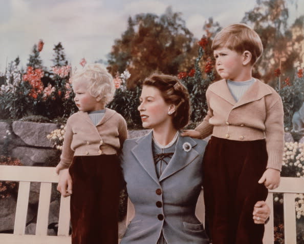 Queen Elizabeth II with Prince Charles and Princess Anne in the grounds of Balmoral Castle, Scotland. Charles is celebrating his 4th birthday.