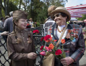 <p>Tatijana Arhipova Efros, a 97 -year-old veteran of World War II, receives flowers at the Antakalnis memorial during Victory Day celebrations in Vilnius, Lithuania, Thursday, May 9, 2019. (AP Photo/Mindaugas Kulbis) </p>