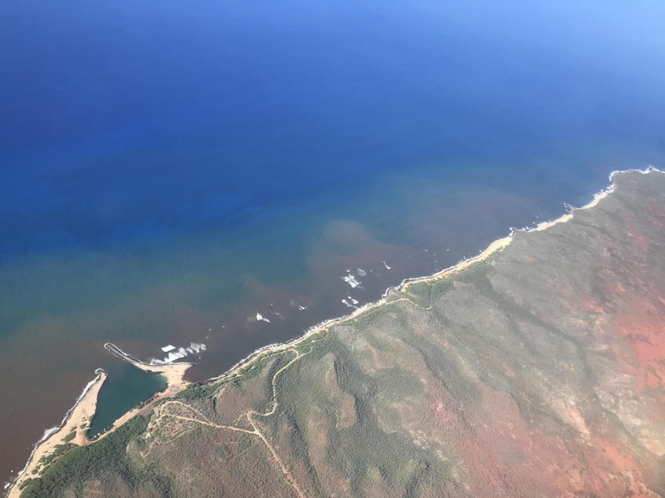 In this undated 2020 aerial photo provided by the Arizona State University's Global Airborne Observatory, runoff from the island of Molokai in Hawaii is shown flowing into the ocean. Axis deer, a species native to India that were presented as a gift from Hong Kong to the king of Hawaii in 1868, have fed hunters and their families on the rural island of Molokai for generations. But for the community of about 7,500 people where self-sustainability is a way of life, the invasive deer are a cherished food source but also a danger to the island ecosystem. Now, the proliferation of the non-native deer and drought on Molokai have brought the problem into focus. Hundreds of deer have died from starvation, stretching thin the island's limited resources. When deer devour fruits, vegetables and other plants, it leads to to erosion and runoff into the ocean that alters the island's coral reef— another important food source. (Global Airborne Observatory, Arizona State University via AP)
