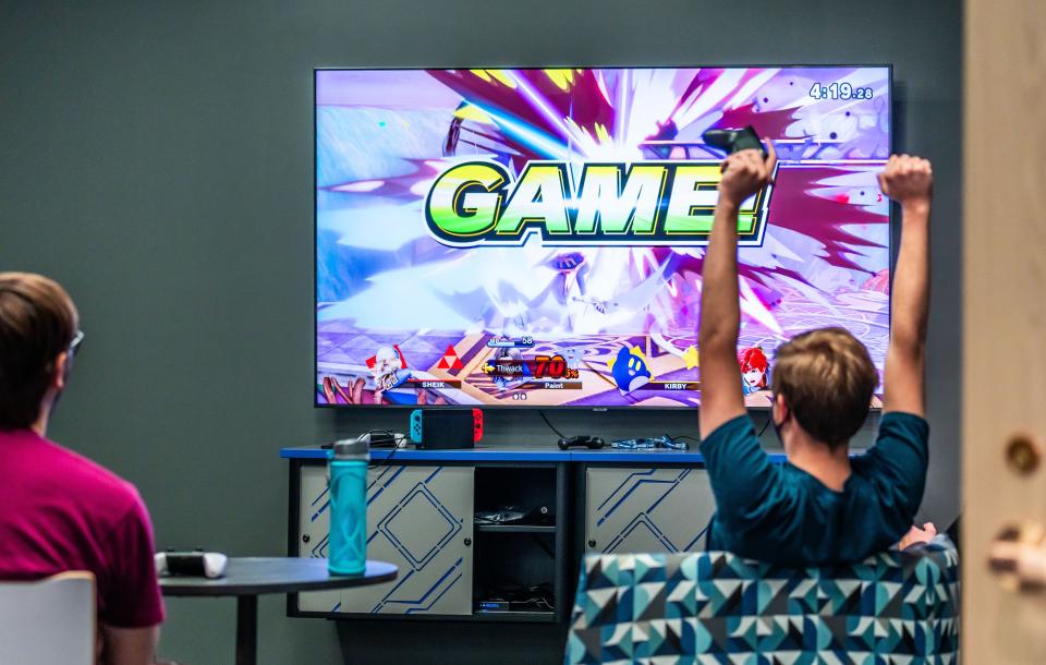 Student Collin Aschenbrenner celebrates winning a game of Super Smash Bros. inside the new esports gaming lab at Waukesha County Technical College.