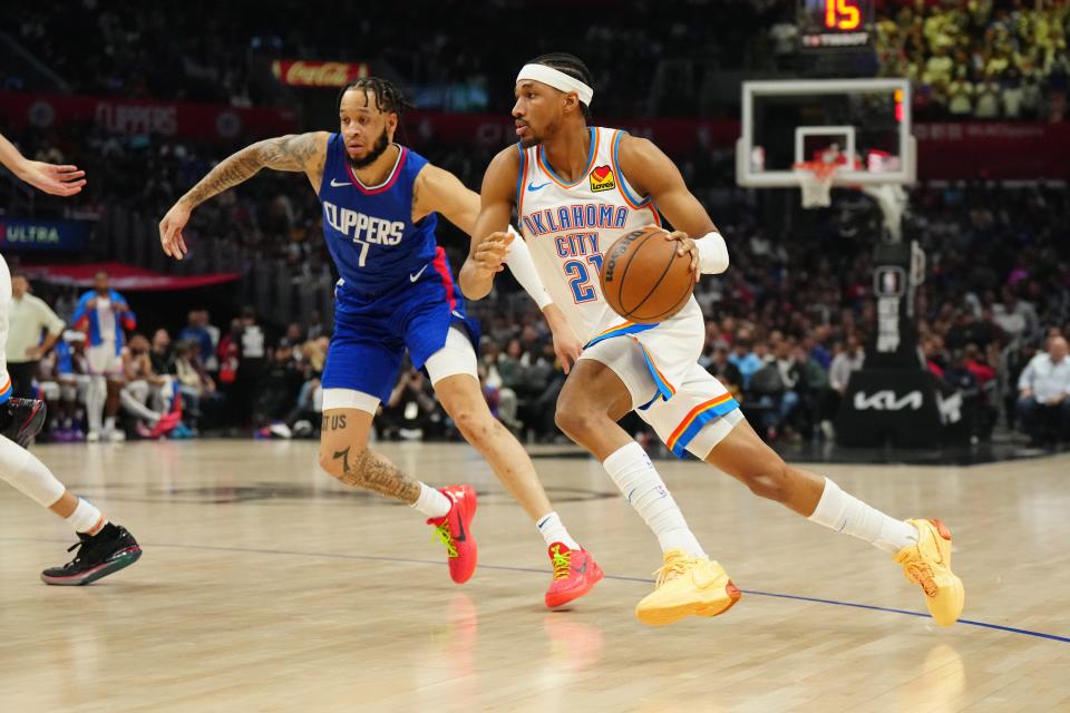 Jan 16, 2024; Los Angeles, California, USA; Oklahoma City Thunder guard Aaron Wiggins (21) dribbles the ball against LA Clippers guard Amir Coffey (7) in the second half at Crypto.com Arena. Mandatory Credit: Kirby Lee-USA TODAY Sports