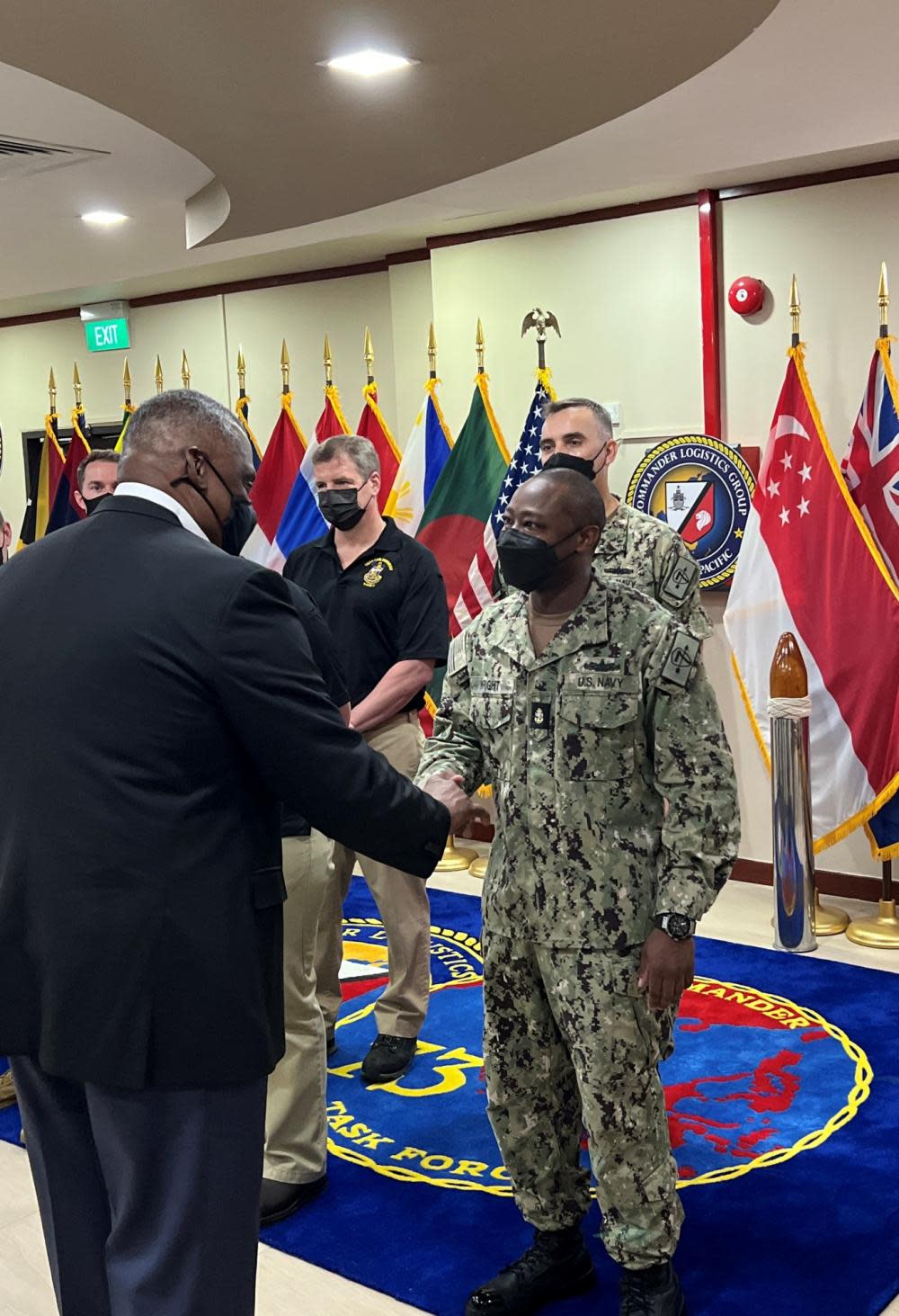 U.S. Secretary of Defense Lloyd Austin, left, shakes hands with Chief Electrician’s Mate Recardo Wright, from Sylvania, Georgia, assigned to Destroyer Squadron (DESRON) 7, during his visit to Commander, Logistics Group Western Pacific/Task Force 73 on June 12, 2022.