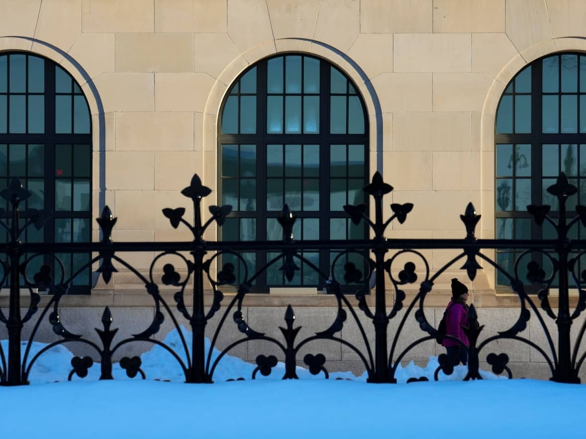 Someone walks past the Wellington Building on Wellington Street in Ottawa Monday. (Sean Kilpatrick/The Canadian Press - image credit)