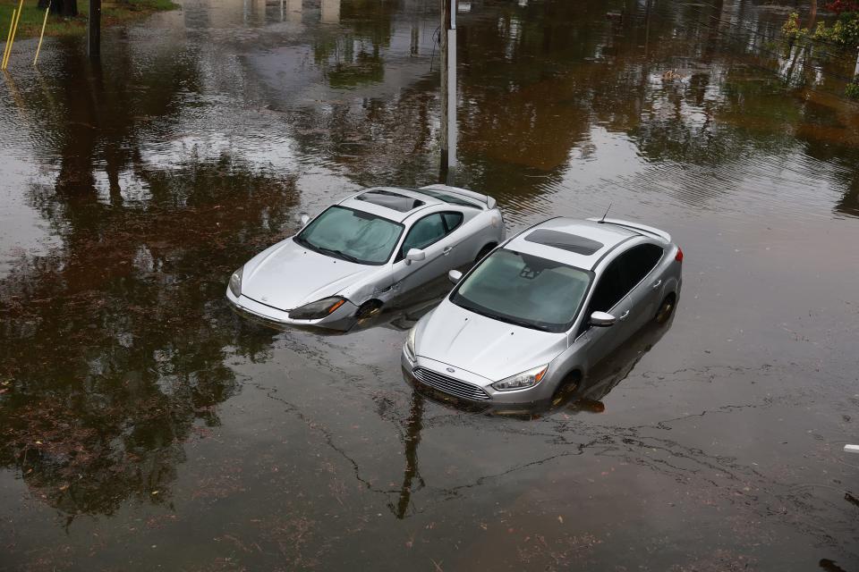 Cars sit in flood waters from Hurricane Idalia in Tarpon Springs, Florida, after it passed offshore on Aug. 30, 2023.