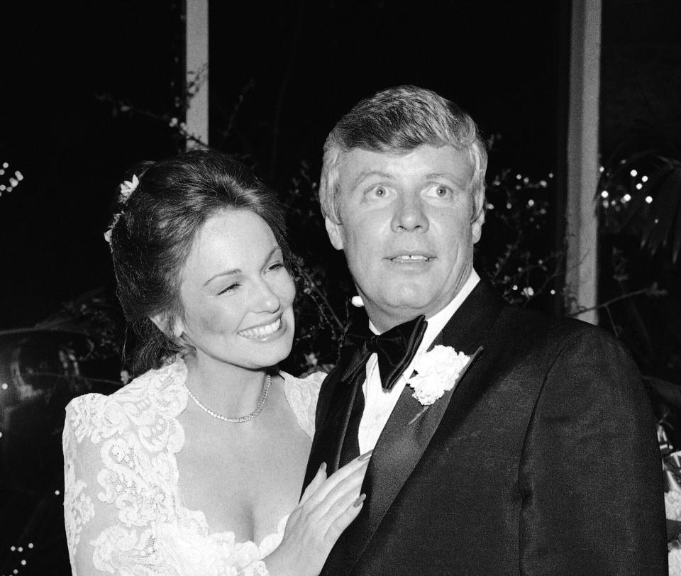 In this Saturday, March 17, 1979 file photo, The former Phyllis George and her new husband Boston Celtics owner John Y. Brown, Jr., pose for cameramen during reception at New York’s Tavern on the Green. (AP Photo/ G. Paul Burnett, File)