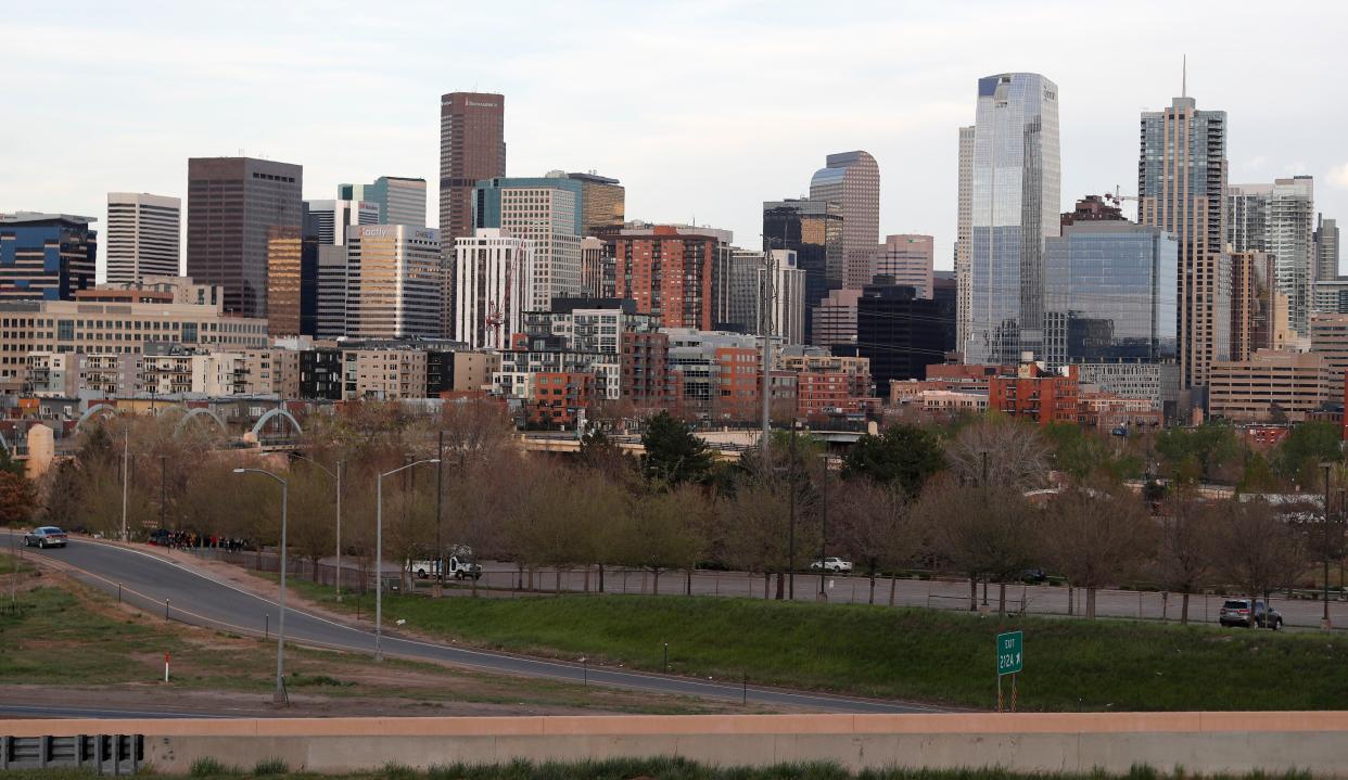 Traffic is barely existent on normally-congested Interstate 25, front, as the road passes by the center of downtown as residents follow the stay-at-home order because of the new coronavirus on Wednesday, May 6, 2020, in Denver, Colo. The order expires Friday, which will allow retail stores and personal service businesses to reopen while following restrictions.