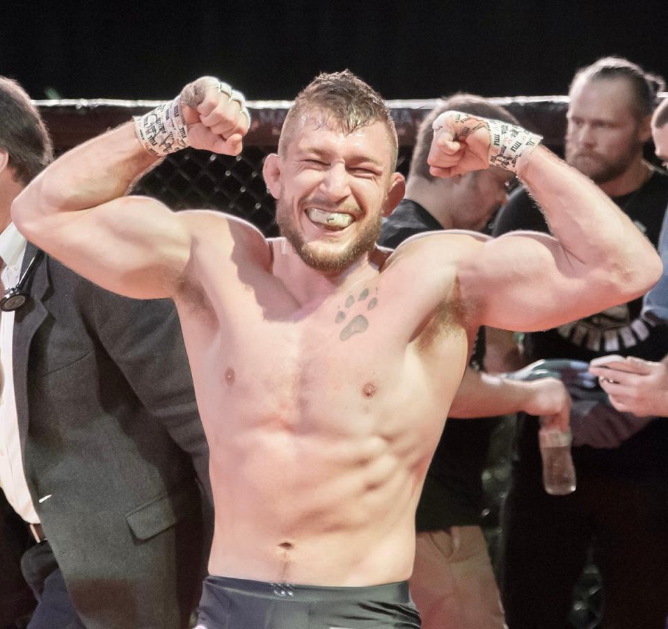 Aaron Kennedy, former Honesdale High School wrestling standout, flexes and smiles just moments after sealing the deal on his first-ever professional mixed martial arts fight. The event took place before a big, raucous crowd at the Sherman Theater in Stroudsburg.