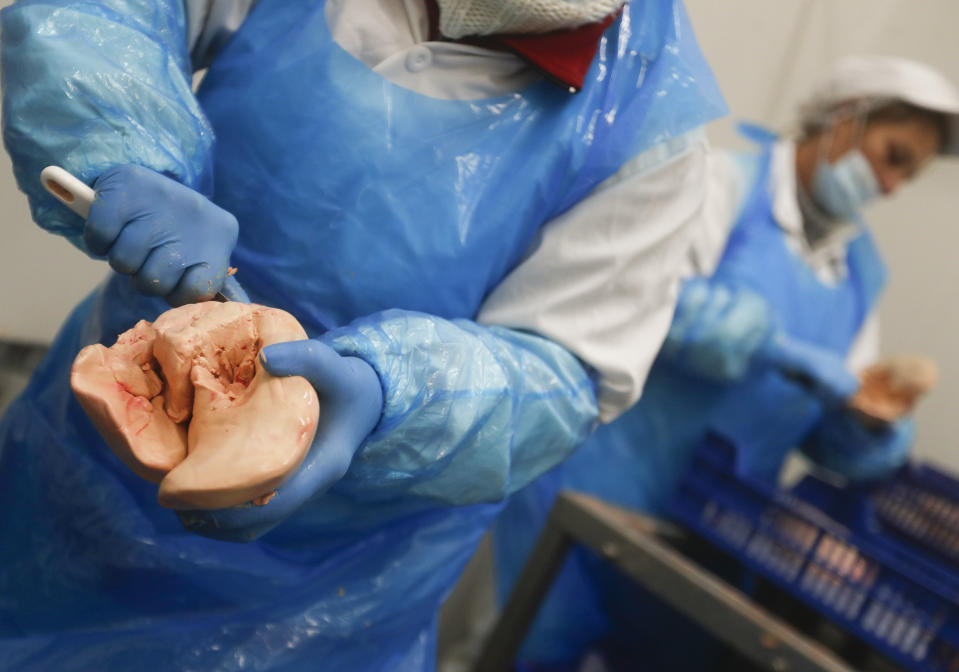 Kosher goose liver is cleaned in a Kosher slaughterhouse in Csengele, Hungary on Jan. 15, 2021. Hungarian Jewish community, exporter of Kosher meat, fear that the European Court of Justice verdict on upholding a Belgian law that banned ritual slaughter could have an affect on other EU member states' regulation on Kosher slaughter. (AP Photo/Laszlo Balogh)