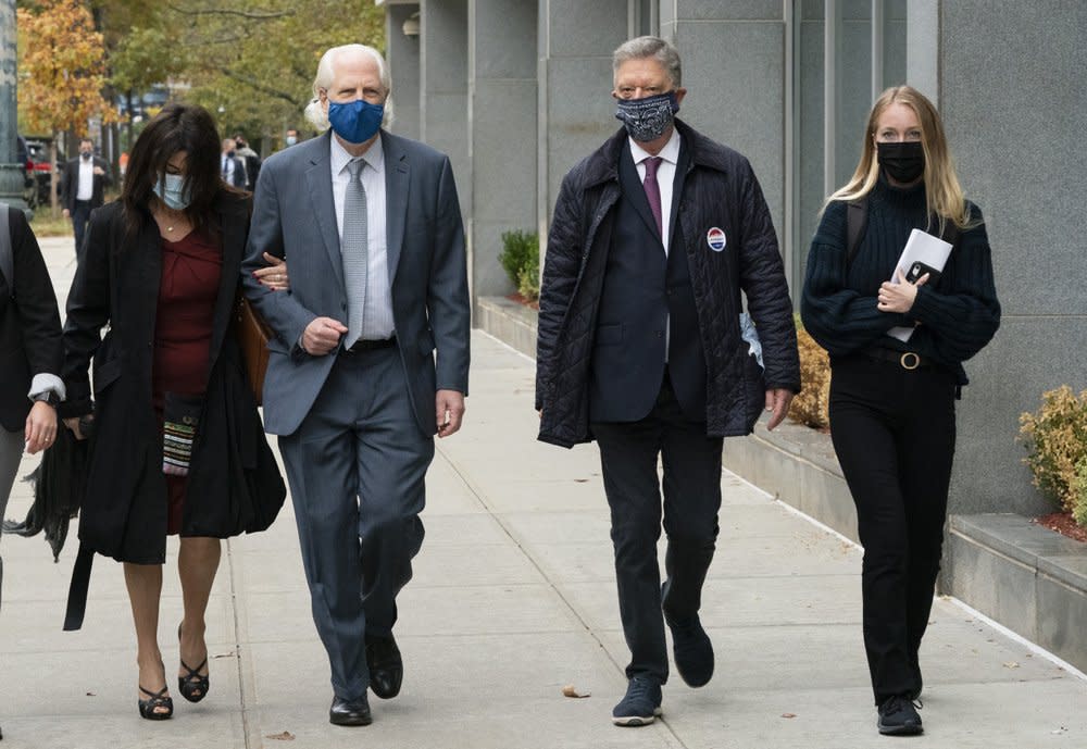 Toni Natalie, left, and India Oxenberg, right, arrive with their attorneys at Brooklyn federal court for a sentencing hearing for self-improvement guru Keith Raniere, Tuesday, Oct. 27, 2020 in New York. (AP Photo/Mark Lennihan)