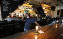 Omar Yeefoon, owner of Shoals Sound & Service vegan restaurant takes a break as talks Tuesday, June 30, 2020, in Dallas. Yeefoon reopened his Dallas restaurant June 10 to "a pretty good reception," after having been shuttered for three months. The comeback was fleeting. After four days, Yeefoon had to shut down again in the face of a COVID-19 resurgence in Texas and lay off two of the four workers he'd brought back. (AP Photo/LM Otero)