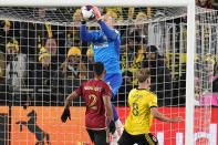 Atlanta United's Brad Guzan, rear, makes a save behind United's Ronald Hernández (2) and Columbus Crew's Aidan Morris (8) during the first half of an MLS playoff soccer match Wednesday, Nov. 1, 2023, in Columbus, Ohio. (AP Photo/Sue Ogrocki)