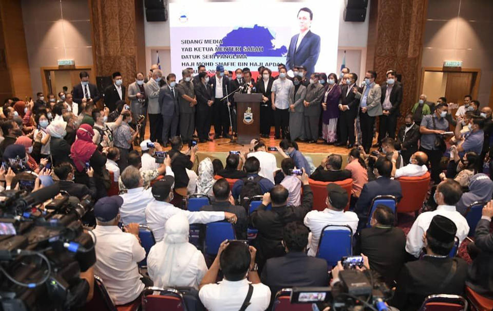 Sabah Chief Minister Shafie Apdal, center, speaks in Kota Kinabalu, Sabah, Malaysia Thursday, July 30, 2020. Shafie dissolved the state parliament to pave the way for polls after a ruling party politician claimed he had majority support of lawmakers to form a new government. (AP Photo)