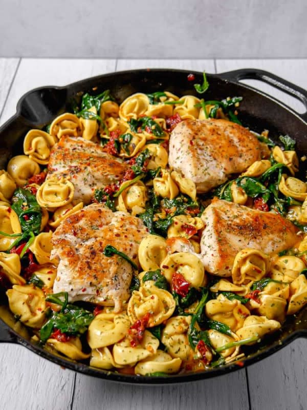<p>Girl With The Iron Cast</p><p>This Tuscan chicken with tortellini dish has juicy pan seared chicken breast, surrounded by cheese tortellini in a creamy sun-dried tomato and spinach sauce. It's an easy and quick 30 minute family dinner.</p><p><strong>Get the recipe: <a href="https://girlwiththeironcast.com/tuscan-chicken-with-tortellini/" rel="nofollow noopener" target="_blank" data-ylk="slk:Tuscan Chicken Tortellini;elm:context_link;itc:0;sec:content-canvas" class="link rapid-noclick-resp">Tuscan Chicken Tortellini</a></strong></p><p><strong>Related: <a href="https://parade.com/846019/andreagleeson/one-pot-chicken-pasta-recipes/" rel="nofollow noopener" target="_blank" data-ylk="slk:17 Best One-Pot Chicken Pasta Recipes;elm:context_link;itc:0;sec:content-canvas" class="link rapid-noclick-resp">17 Best One-Pot Chicken Pasta Recipes</a></strong></p>