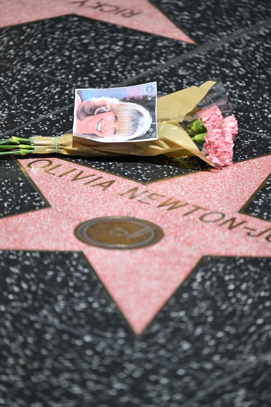 Flowers for Olivia Newton-John are placed on her star on the Hollywood Walk of Fame - Credit: Michael Bruckner for Deadline