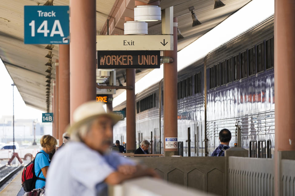People wait on an Amtrak train platform at Union Station in Los Angeles as stoppages are announced on Wednesday, Sept. 14, 2022. Some Amtrak routes will be disrupted due to freight railroad labor negotiations. (AP Photo/Ashley Landis)