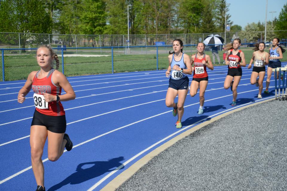 Sam Sexton (381) of Bedford runs in a heat of the 1,600 meters with teammate Katelyn Dec (356) and Monroe’s Viktoria Bloniarz (244) Friday in the Southeastern Conference Red Championships.