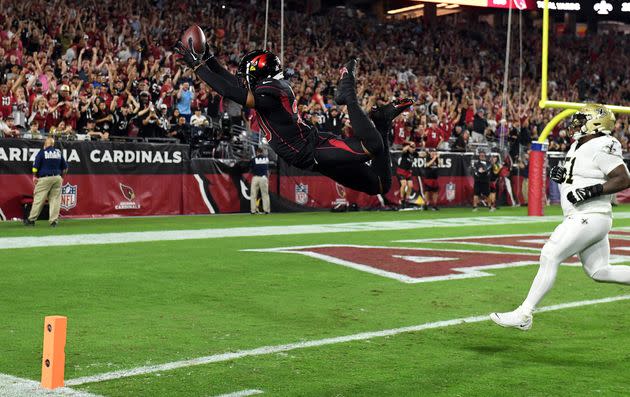 Marco Wilson of the Arizona Cardinals dives into the end zone for a touchdown after intercepting a pass in the game Thursday against the New Orleans Saints in Glendale, Arizona. (Photo: Norm Hall/Getty Images)