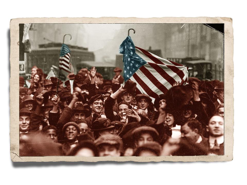 A crowd celebrates the end of World War I on Nov. 11, 1918, on a street in the Loop area of Chicago, Illinois. Health officials in several cities would later attribute the large gatherings to surges in influenza.