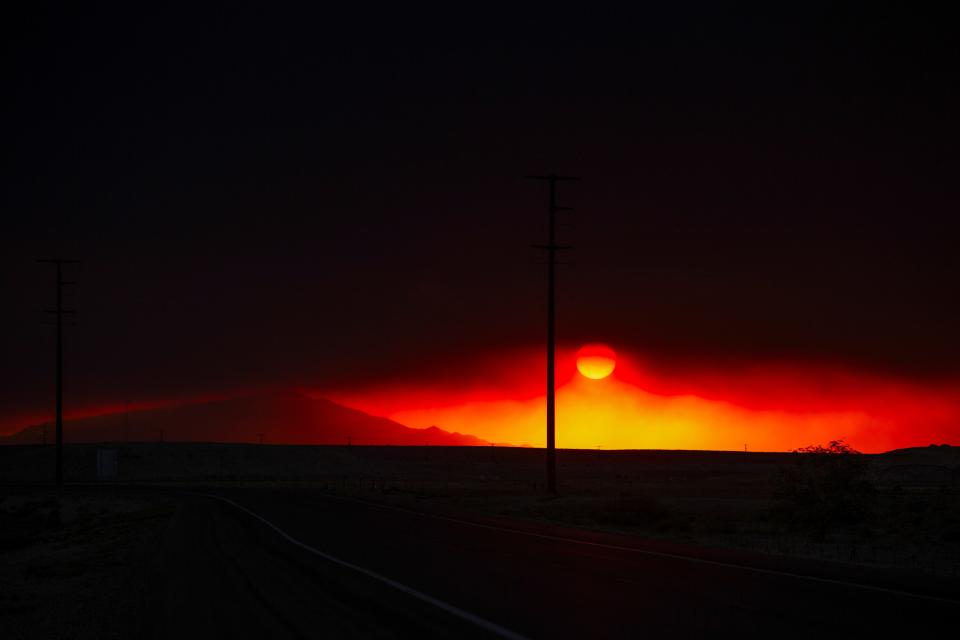 Smoke plumes from the South Fork Fire that caused mandatory evacuations in Ruidoso, New Mexico, are seen from the evacuation route in Roswell, New Mexico, U.S. June 17, 2024. REUTERS/Kaylee Greenlee Beal