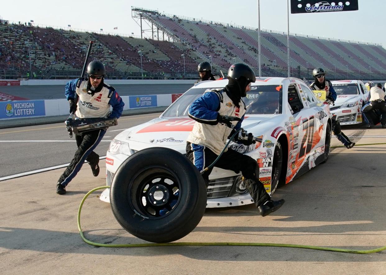 Jesse Love's pit crew changes his tires on pit road during the August 2023 ARCA Menards Series Henry Ford Health 200 at Michigan International Speedway.