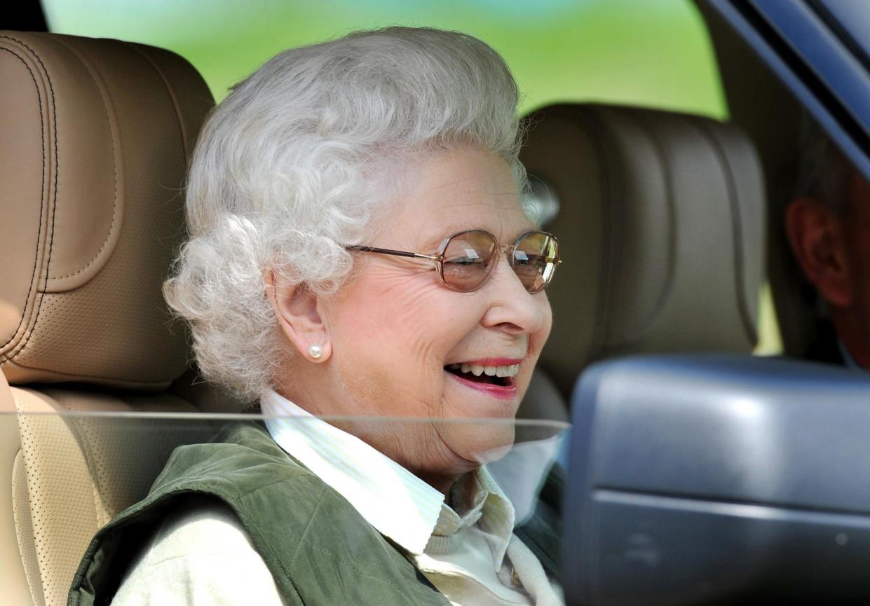 Queen Elizabeth driving her green Jaguar