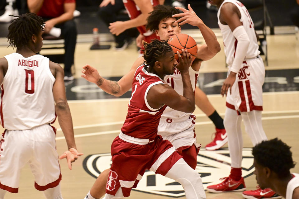 Stanford guard Daejon Davis (1) drives to the basket as Washington State forward DJ Rodman (11) defends during the first half of an NCAA college basketball game, Saturday, Feb. 20, 2021, in Pullman, Wash. (AP Photo/Pete Caster)