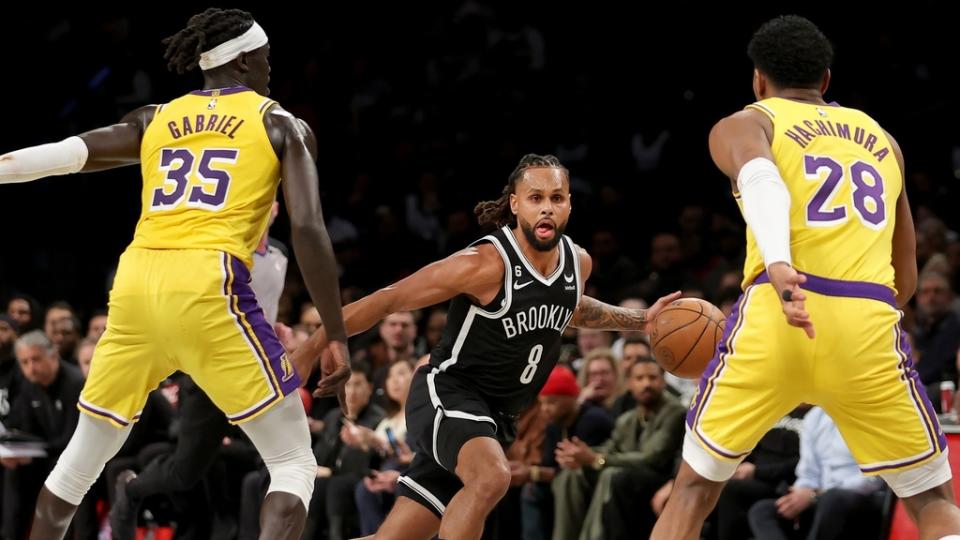 Jan 30, 2023; Brooklyn, New York, USA; Brooklyn Nets guard Patty Mills (8) brings the ball up court against Los Angeles Lakers forwards Wenyen Gabriel (35) and Rui Hachimura (28) during the second quarter at Barclays Center.