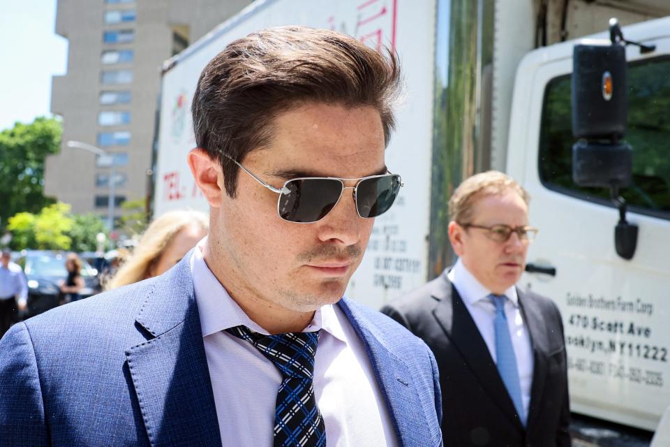 Ryan Salame wearing sunglasses and a blue suit.