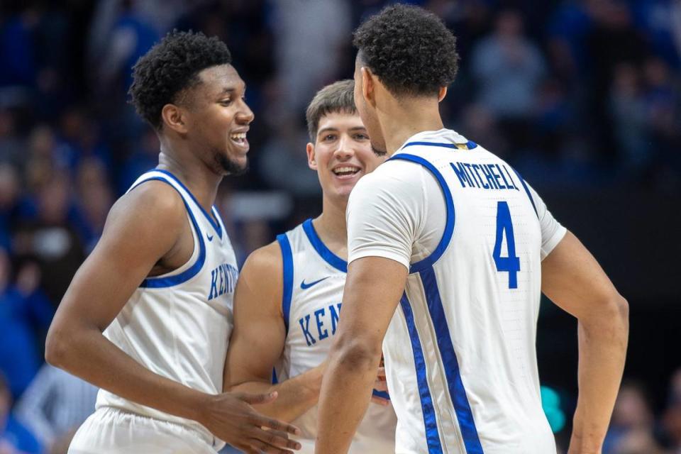 Kentucky guard Reed Sheppard, center, is congratulated by teammates Justin Edwards, left, and Tre Mitchell after getting a rebound during a game earlier this season.