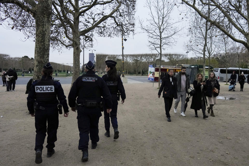 French policemen patrol around the Eiffel Tower, in Paris, Thursday, Dec. 7, 2023. Less than a year before the 2024 Paris Olympic Games, with an opening ceremony on the nearby Seine river, the bar was already high. But the security challenge went up with the deadly weekend knife attack that killed a tourist near the Eiffel Tower, a tourist magnet that is the symbol of Paris. (AP Photo/Thibault Camus)