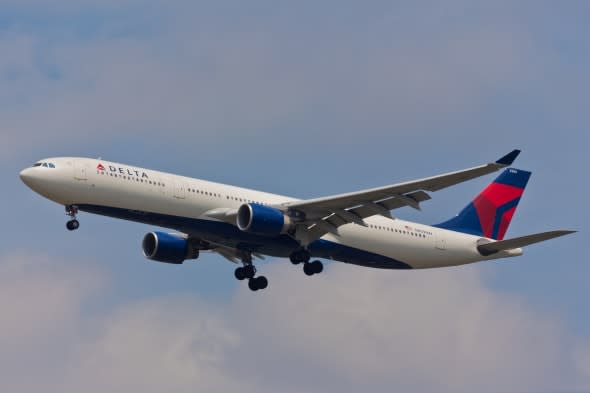 NEW YORK - JANUARY 12: Airbus A330 approaches at dusk to JFK Airport located in New York, USA on January 12, 2012. Delta is one