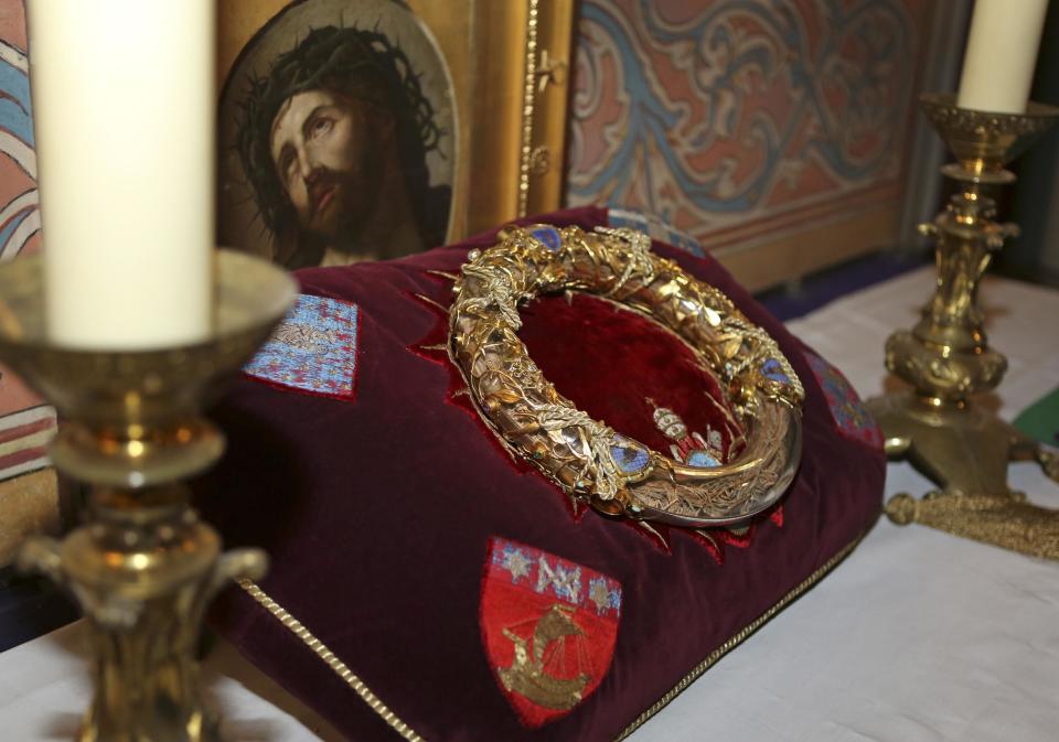 A crown of thorns which was believed to have been worn by Jesus Christ and which was bought by King Louis IX in 1239 is presented at Notre Dame Cathedral in Paris, Friday March 21, 2014. To mark the 800th anniversary of Louis IX's christening, the crown of thorns will be displayed outside Notre Dame, at the Collegiate Church of Poissy, where King Louis IX was christened. (AP Photo/Remy de la Mauviniere)