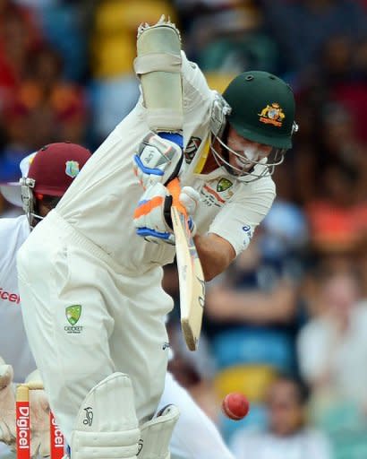 Australian cricketer Michael Hussey plays a shot during the third day of the first-of-three Test matches between Australia and West Indies at the Kensington Oval stadium in Bridgetown. West Indies held the upper hand at the end of the third day of the first Test here on Monday as they reduced Australia to 248 for 5, still trailing by 201 runs