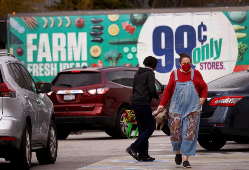 Cars try to find parking as customers make their way to the 99 Cent Only