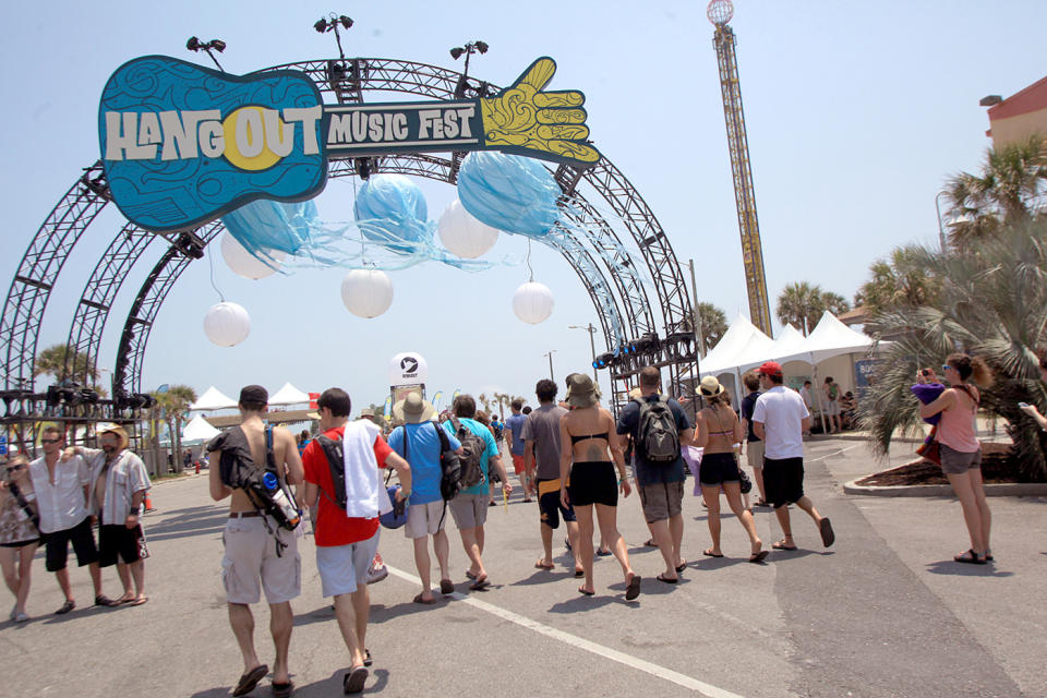 FILE - This May 20, 2011 file photo shows festival goers arrive for the three day Hangout Music Festival in Gulf Shores, Ala. Despite heat, humidity, crowds and costs, music festivals are more popular than ever, attracting millions of fans, with 270 festivals of various types annually in the U.S. and more than 800 in 57 countries. (AP Photo/Mobile Press-Register, Kate Mercer, file)