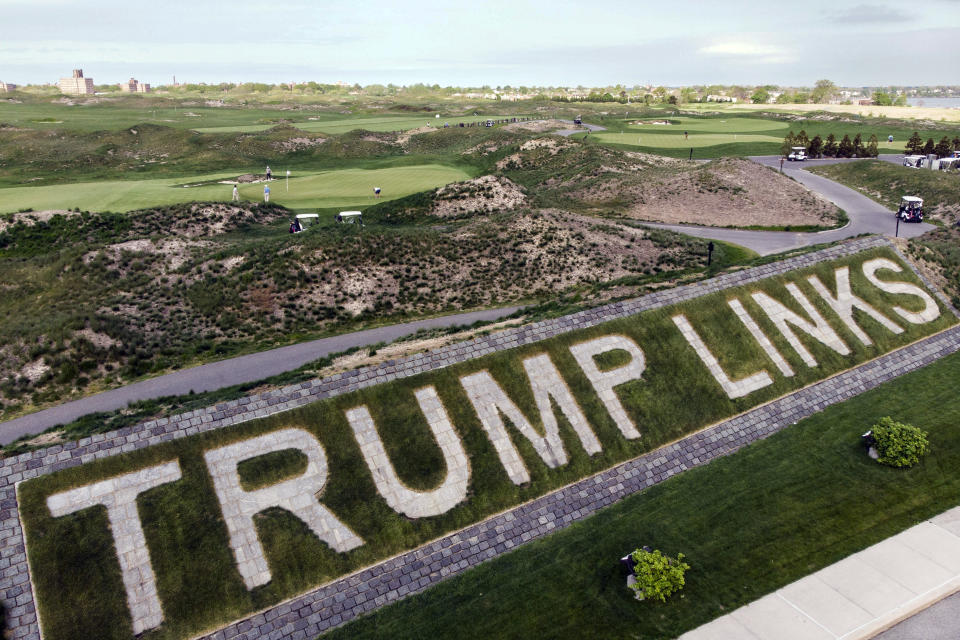 FILE - Patrons play the links as a giant branding sign is displayed with flagstones at Trump Golf Links, at Ferry Point in the Bronx borough of New York, May 4, 2021. A New York City-owned golf course managed by former President Donald Trump's business is expected to host a Saudi Arabia-supported women's tournament in October, city officials said Friday, Aug. 26, 2022. (AP Photo/John Minchillo, File)